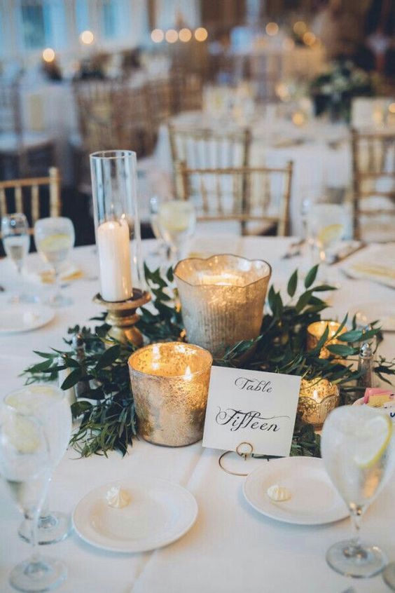  greenery centerpiece with gold votives and calligraphy table number 