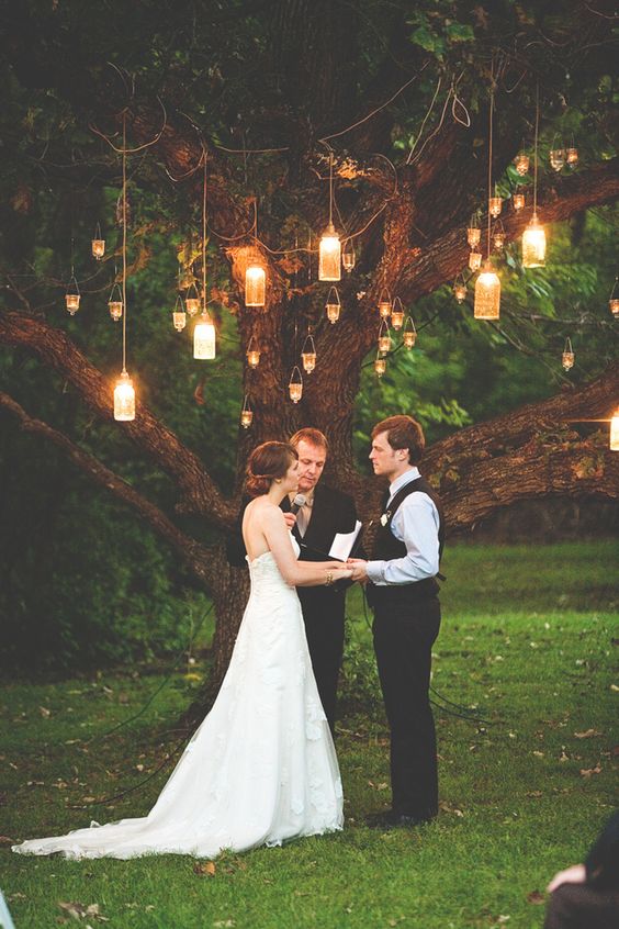 Romantic Mason jar lighting illuminates this wedding